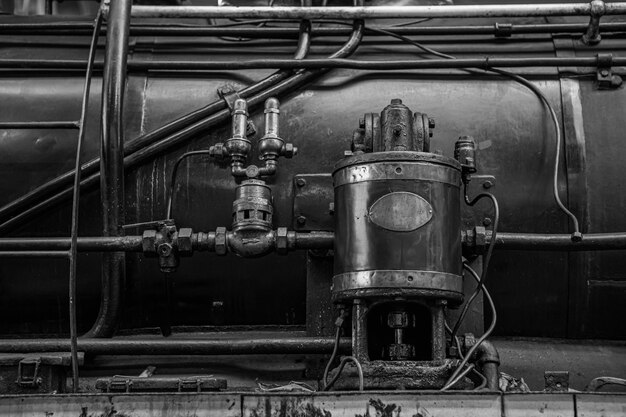 black-white-long-used-metal-device-filled-with-oil-stains-is-mounted-steam-locomotive_1048944-28804513.jpg