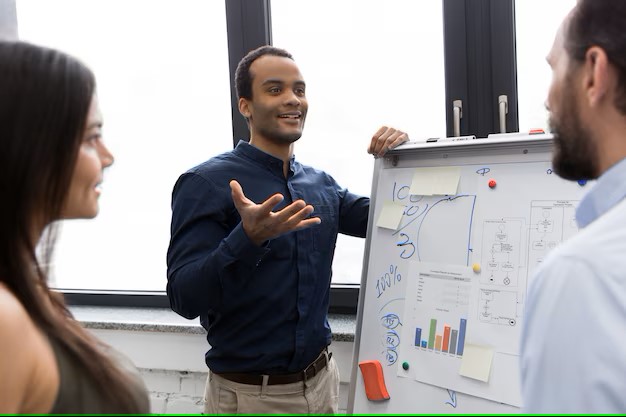 young-manager-presenting-whiteboard-his-colleagues_171337-5964.jpg